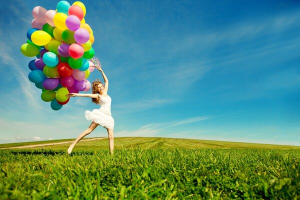 A girl in a light white dress with colorful balloons