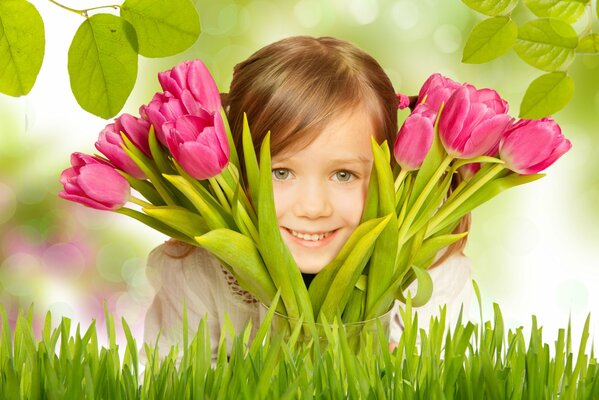 A little girl with a bouquet of tulips