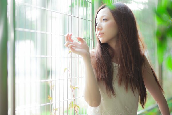 Asian girl in a thoughtful mood