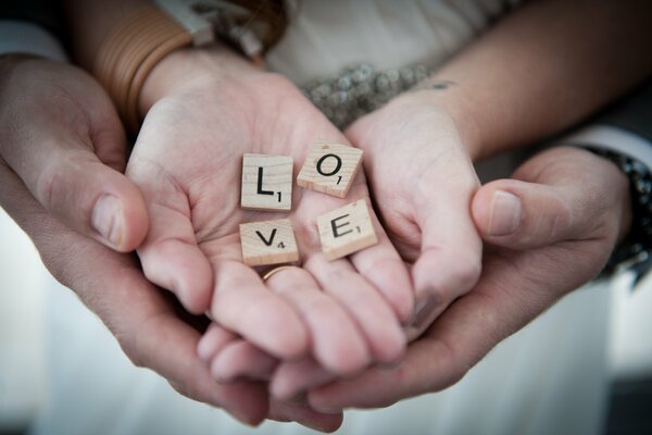 Guy and girl hold love on their palms