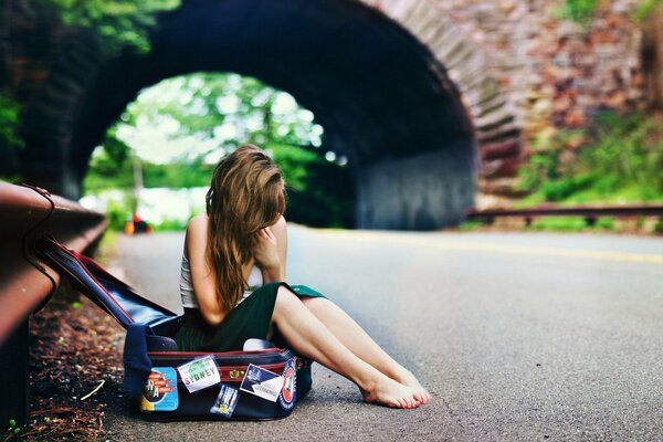 Barefoot girl on the road waiting