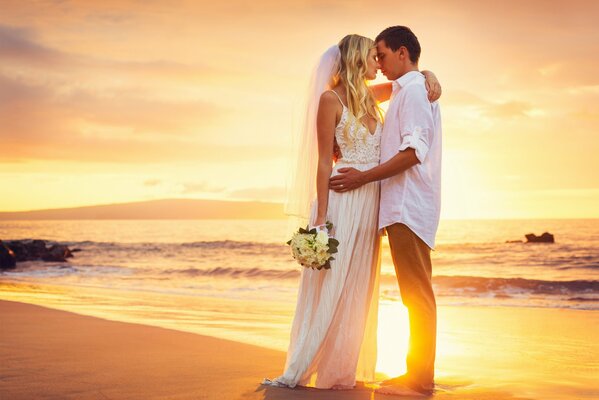 Wedding photo on the background of the sunset sea