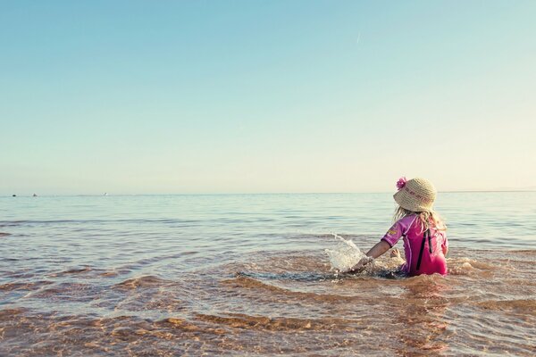 Fille au chapeau sur la mer