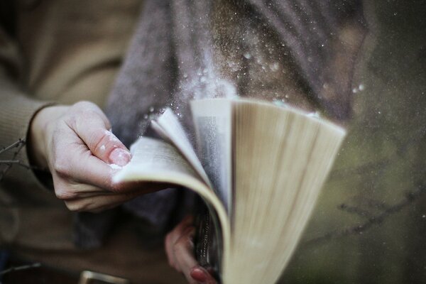 A dusty book in his hands