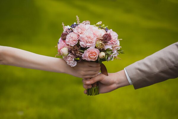 Husband and wife holding a bouquet