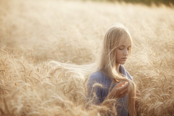 A girl in a field with rye-colored hair