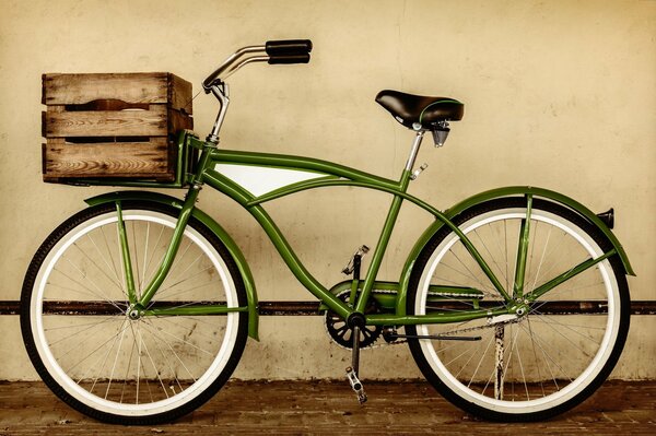 Green bicycle with wooden basket