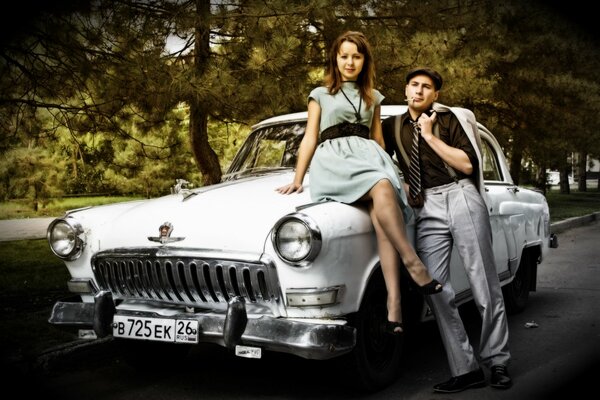 Couple. Retro car. Girl in a dress