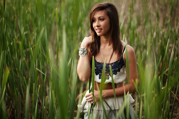 Smiling girl in the tall grass