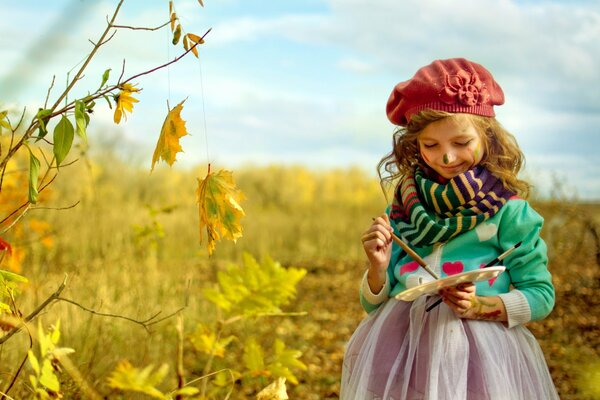 Chica artista y pintura de otoño