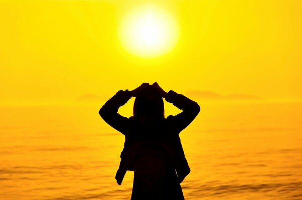 A girl at sunset by the sea