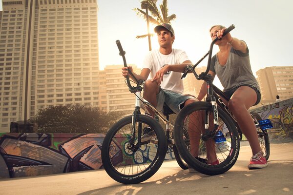 Girl and man on bmx in the city