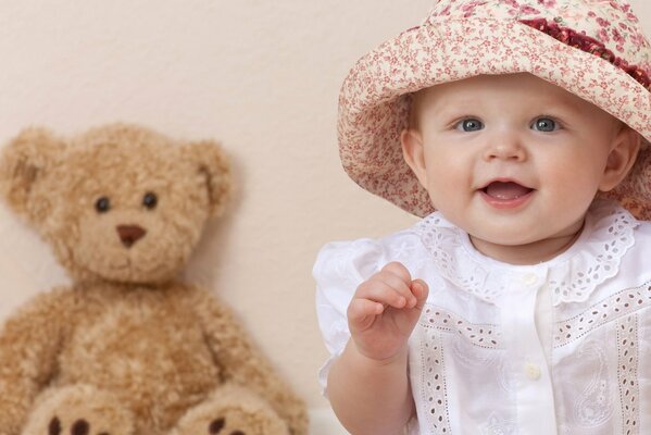 Beautiful girl with blue eyes and a teddy bear