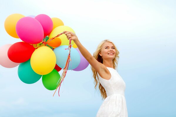 Happy and free girl with balloons in her hands