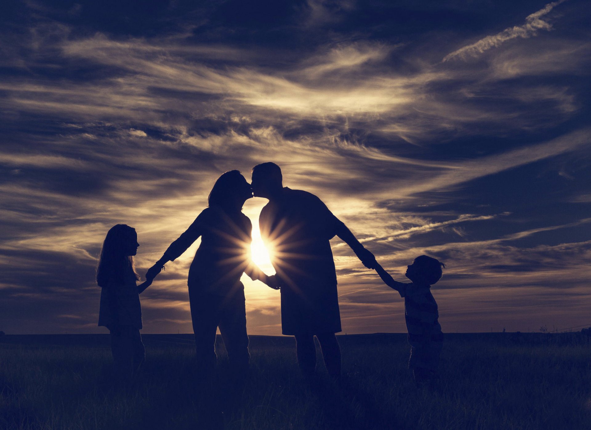 family children kiss ray of sun