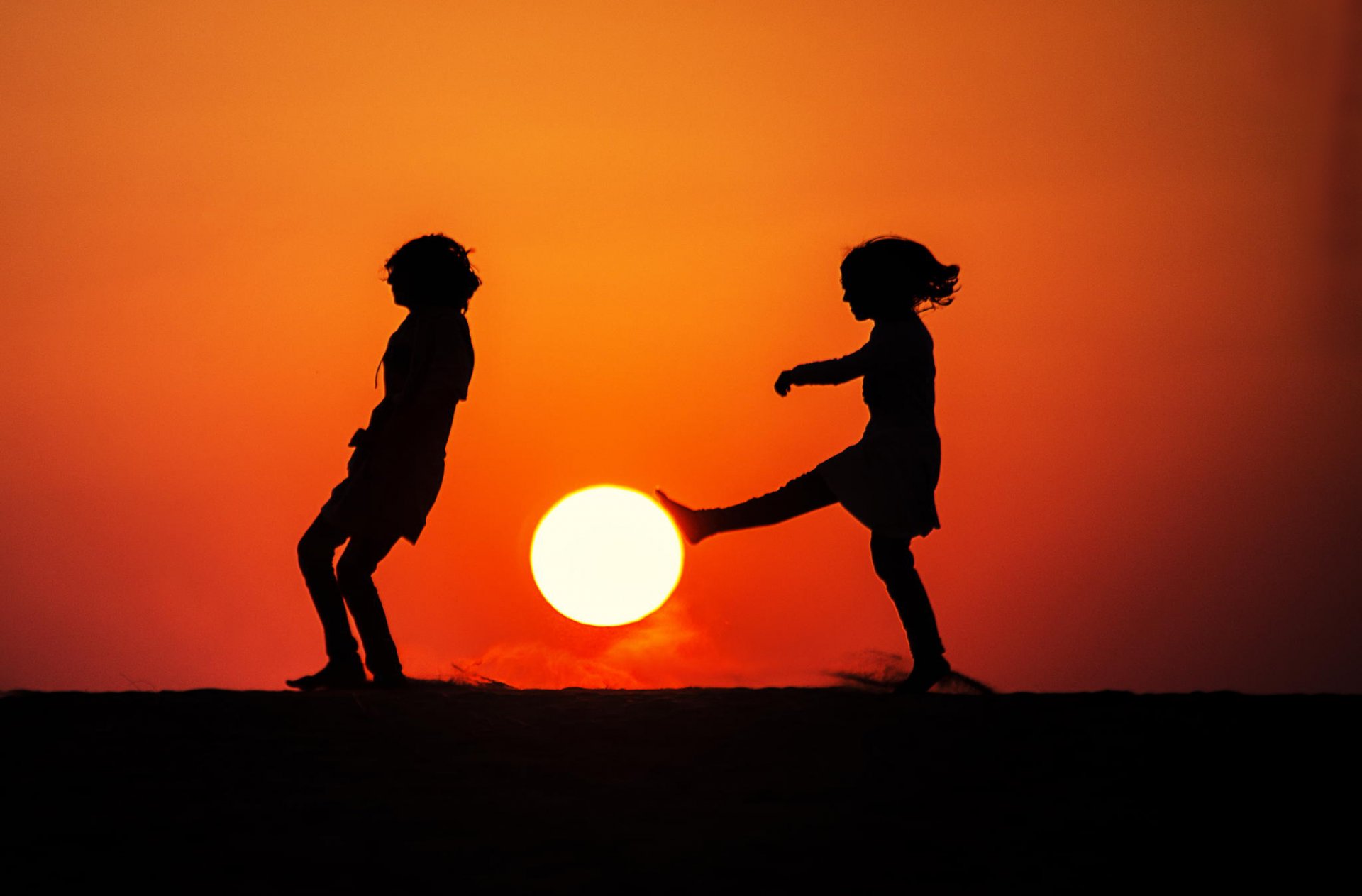 children silhouettes sun