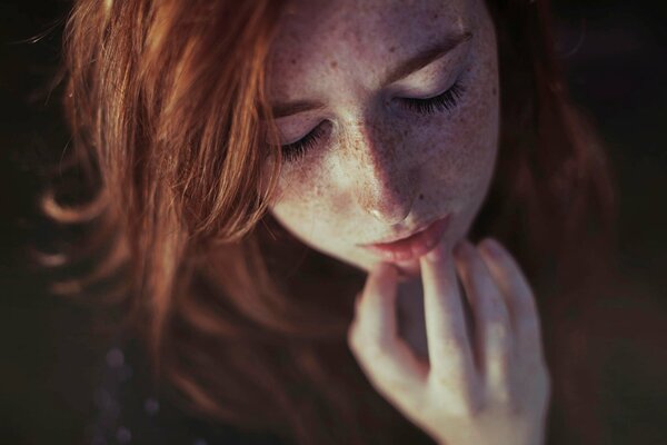 Red-haired girl with freckles top view