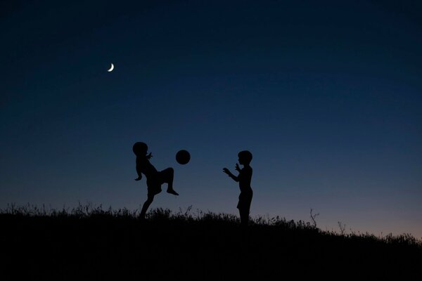 Silhouettes of children at night