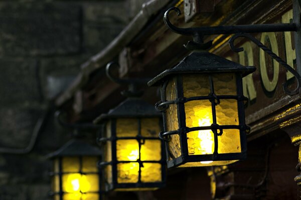 Night lights in a forged frame on the facade of the house