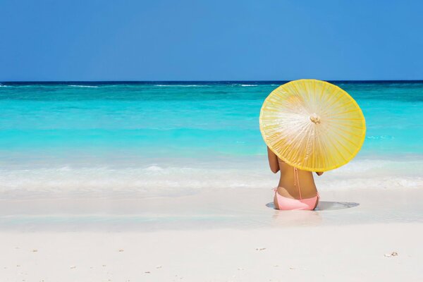 At sea with an umbrella girl on the beach