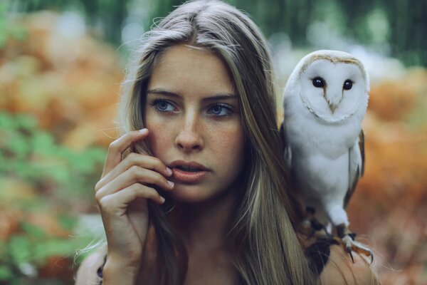 The portrait shows a pet owl with freckles