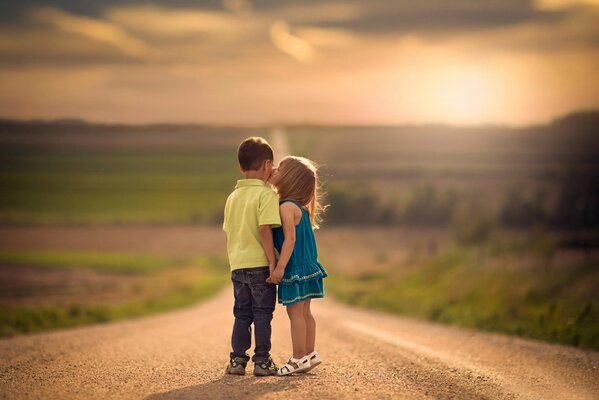 A boy and a girl on the road. The first kiss