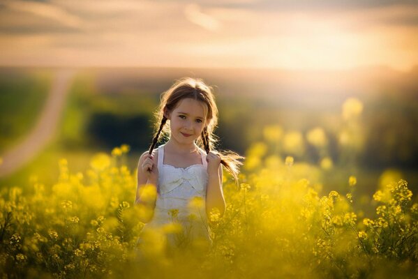 Photos with a summer atmosphere. A girl with pigtails by the road