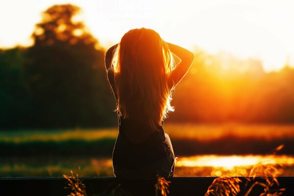 Silhouette of a girl at evening sunset