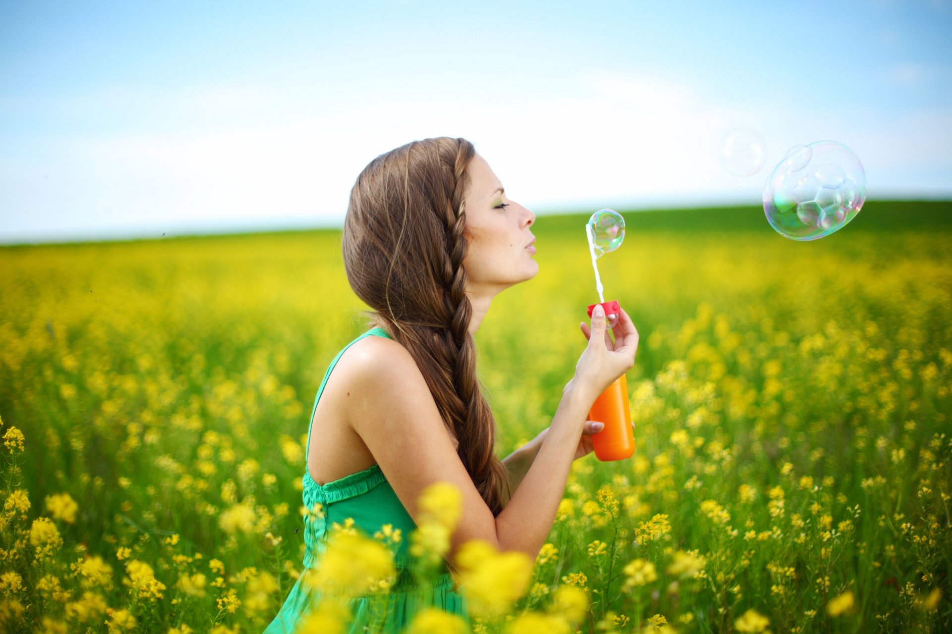 mood girl brown-haired pigtail hairstyle summer dress soap bubbles plants nature flowers flowers yellow background sky woman brunette positive joy happiness freedom hands smile plant trees tree leaves leaves wide