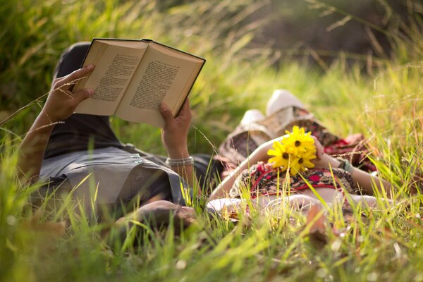 A couple in love in a meadow reading