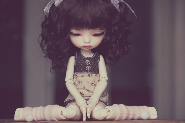 Sad doll in pink knee socks