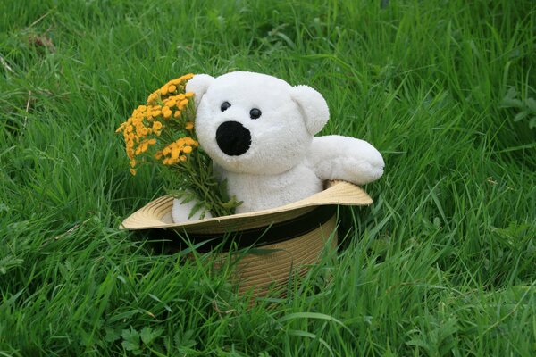 A white bear with flowers in a hat