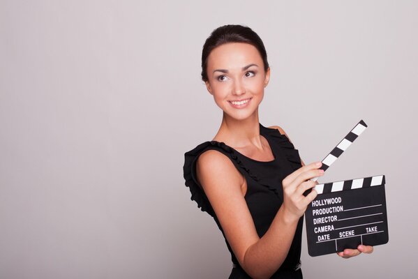 A beautiful girl of the camera group holds a firecracker