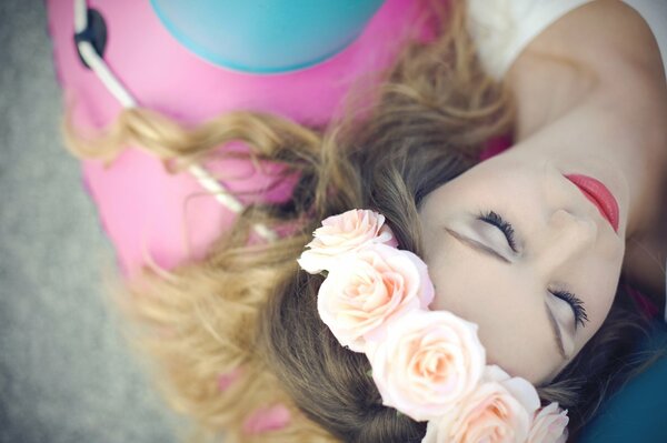 Brunette girl in nature with roses