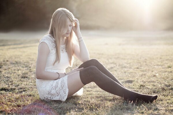 Thoughtful girl in a white dress