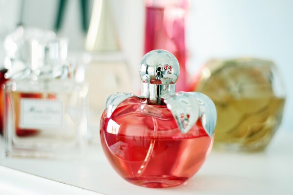Perfume for mood standing on the shelf and reflected in the mirror