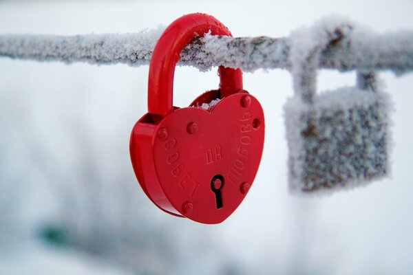 There is a red heart-shaped lock on the bridge