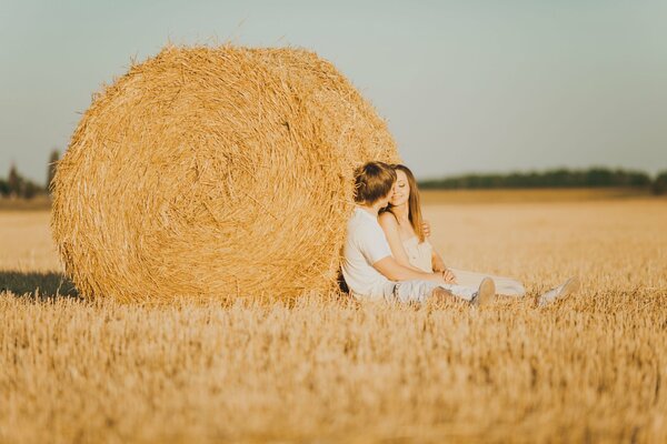 A couple in love near a haystack