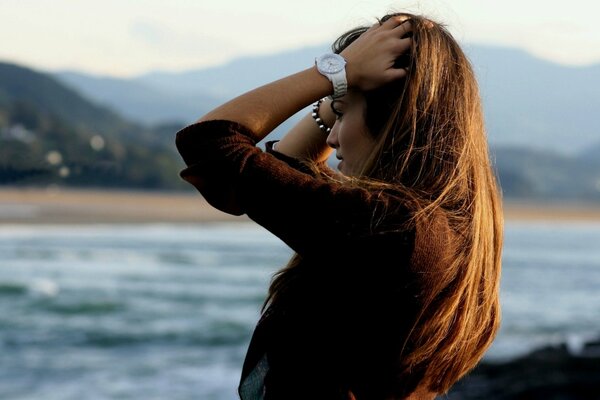 A girl on the seashore and mountains