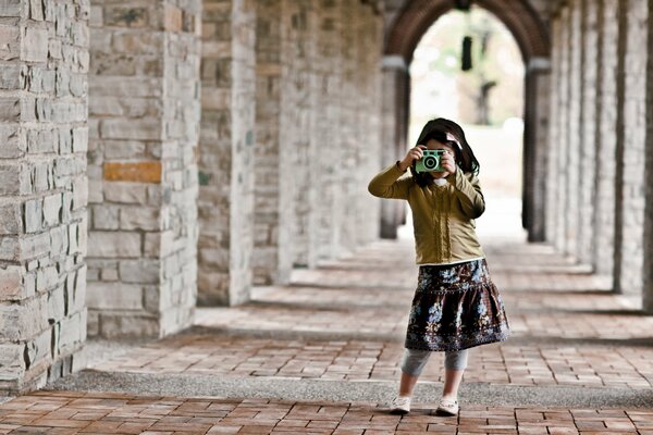 A girl taking pictures in an arched vault