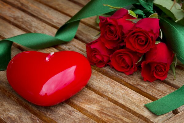 Heart and red roses with green ribbon