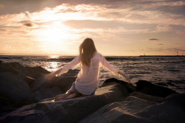 Moscow mood. A girl on her knees in a sea sunset