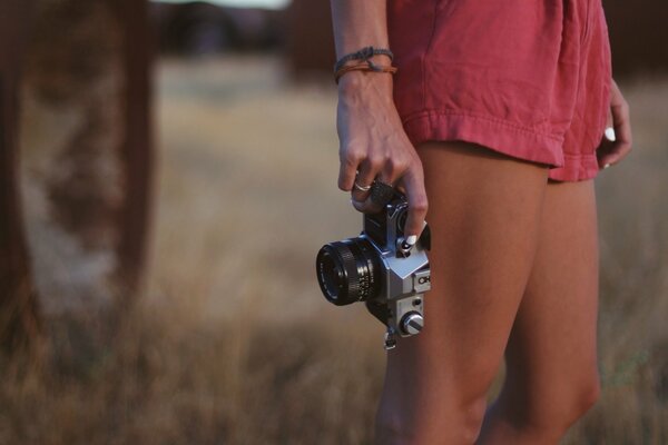 A girl with a camera with beautiful legs