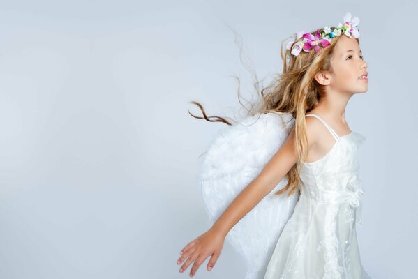 A girl with wings and a wreath on a white background