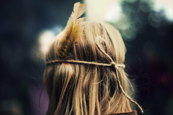 Hippie girl with a feather in her hair