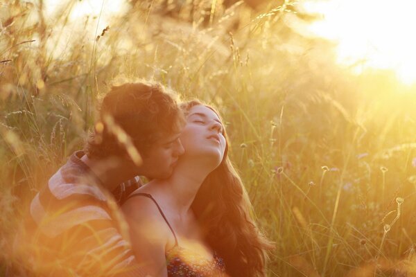 A couple in love in a field on the grass