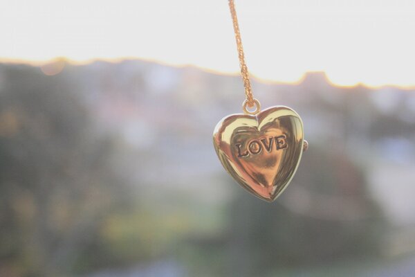 A chain with a heart is a gold decoration on the neck