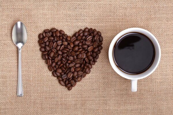 A spoon, coffee beans, a cup of coffee and love