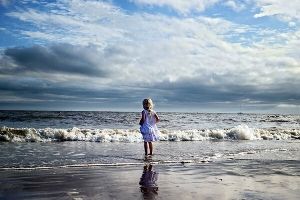 A girl on the sea in the clouds of reflection