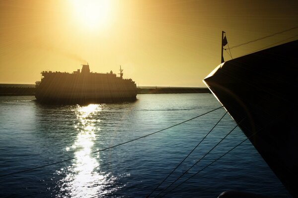 A ship in the ocean at sunset